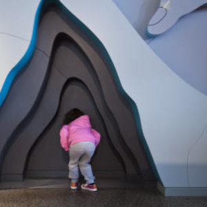 EXPERIENCE 
Child exploring inside the Visitor Centre at Giant's Causeway, County Antrim, Northern Ireland.