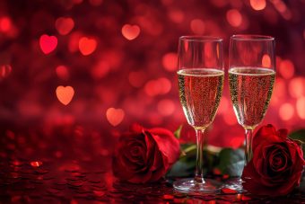 Romantic champagne glasses and red roses on heart background for valentine s day celebration